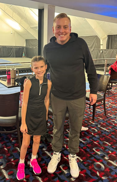 Will Gross standing with a junior player